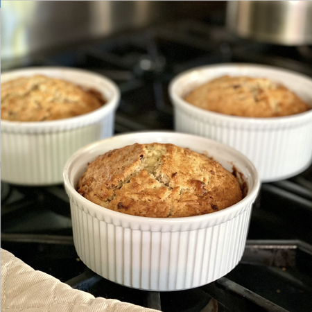 banana bread in ramekins cooling on a stove