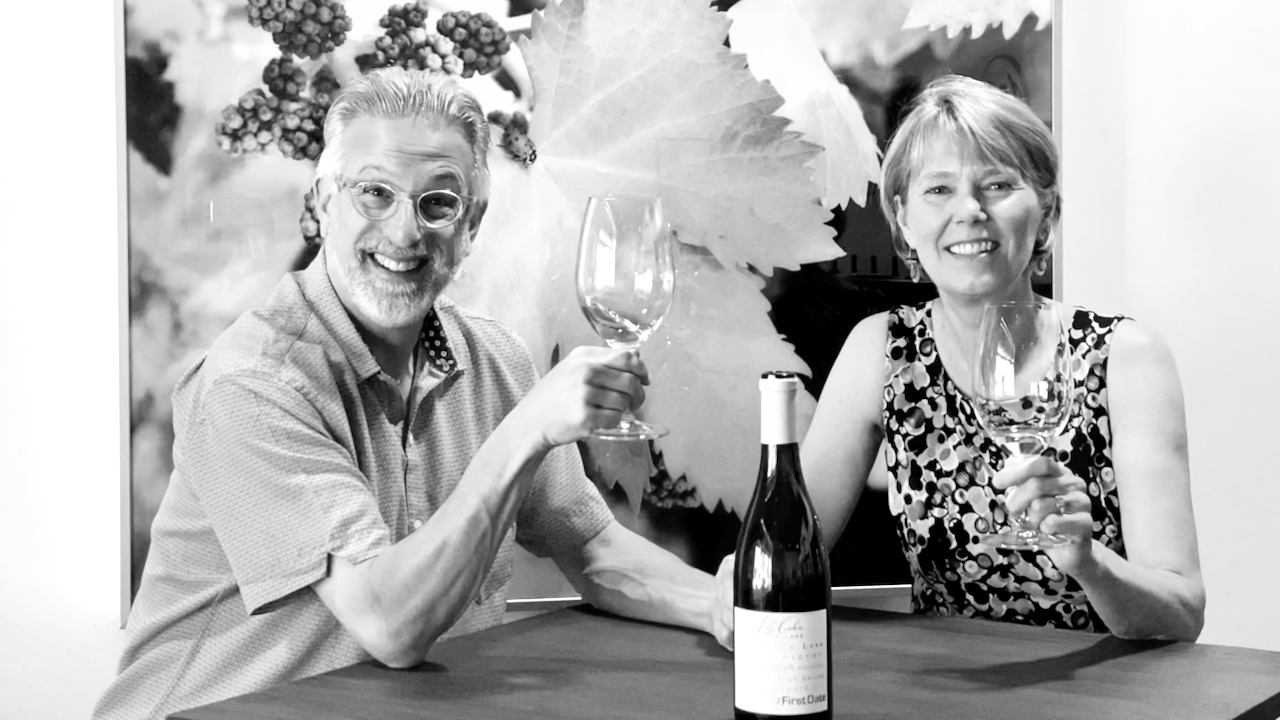 jeff and alexandra cohn smiling and holding their glasses up to cheers