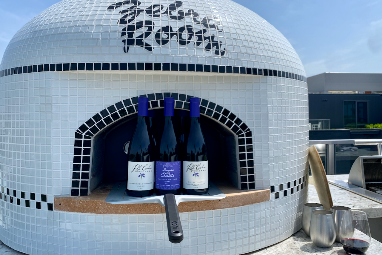 Jeff Cohn Cellars Syrahs in front of a pizza oven