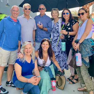 alexandra cohn taking a picture with wine club members at a party
