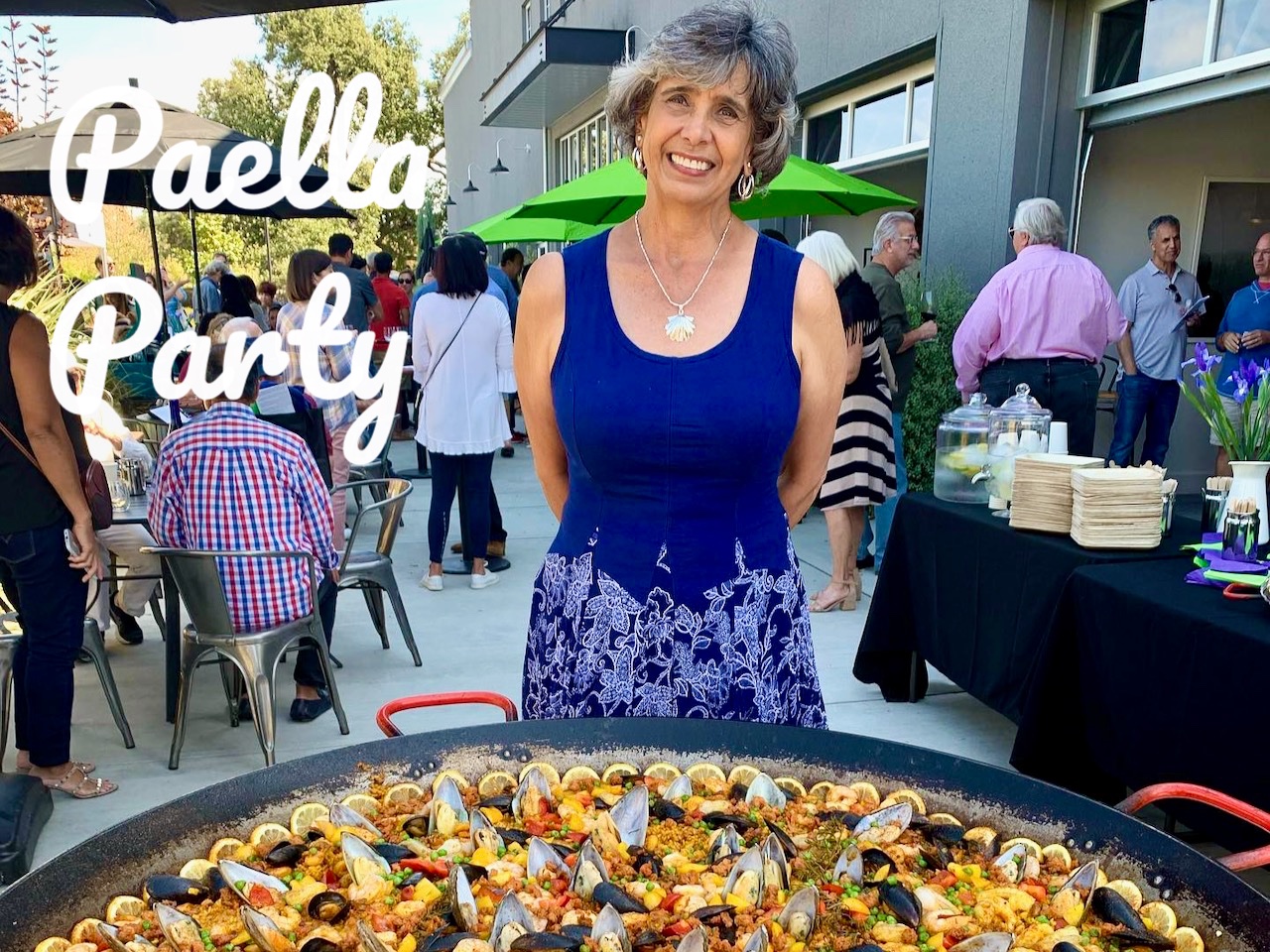 Von stands in front of a giant pan of Valencia paella at our fall club event 