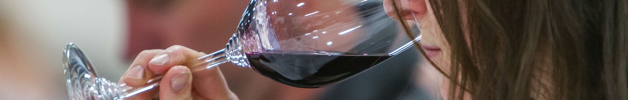 A woman smells the aroma of a Rhone varietal wine in stemware