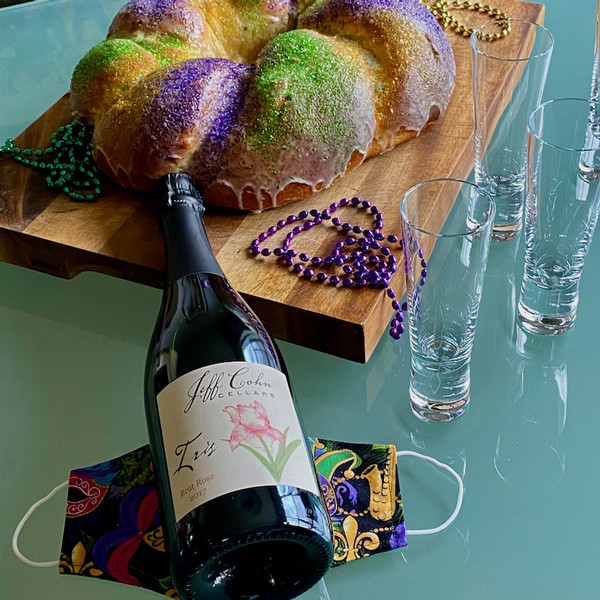 Jeff Cohn Iris Brut Rose with a Mardi Gras King Cake on a table