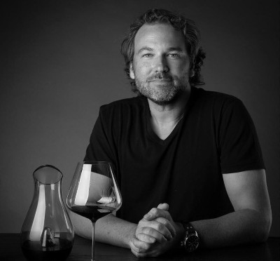 wine critic jeb dunnuck by a glass of wine and a decanter